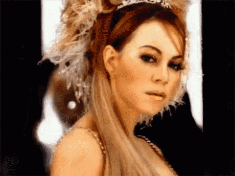 a woman wearing a tiara and feathers in her hair .