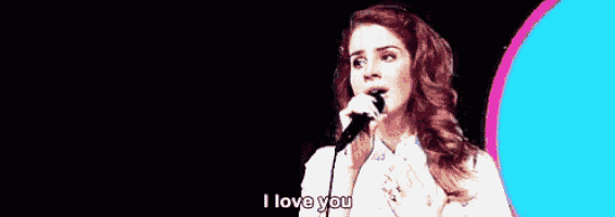 a woman is singing into a microphone with the words `` i love you '' .