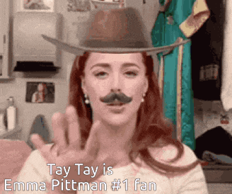 a woman is wearing a cowboy hat and a fake mustache