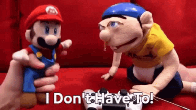a mario and a jeff puppet are sitting on a couch .
