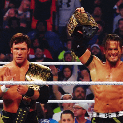 two men in a wrestling ring one of whom is wearing a belt that says ' wwe ' on it