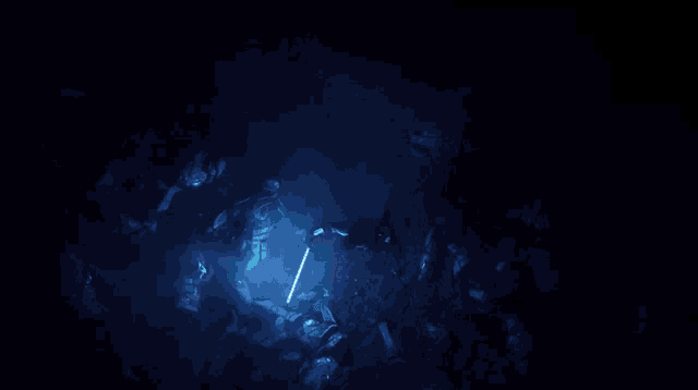 a man is holding a blue light saber in his hand