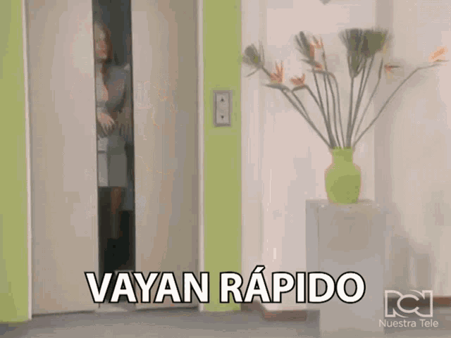 a woman is standing in a doorway with the words " vayan rapido " written on it