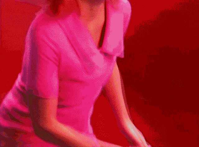 a blurry picture of a woman 's breasts with a purple background