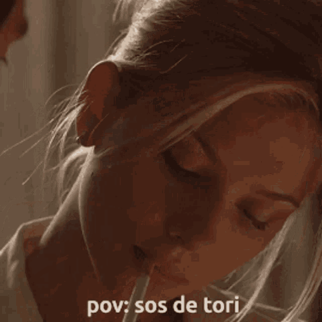 a close up of a woman covering her mouth with her hand and the words pov sos de tori below her