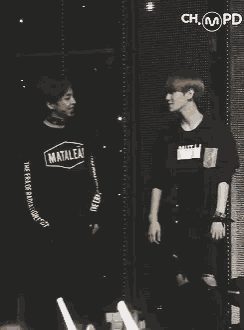 two men are standing in front of a wall that says champ
