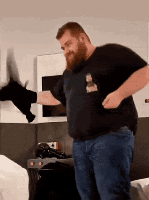 a man with a beard wearing a black shirt with a picture of a woman on the front