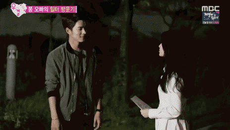 a man and a woman are holding hands with a mbc logo in the background