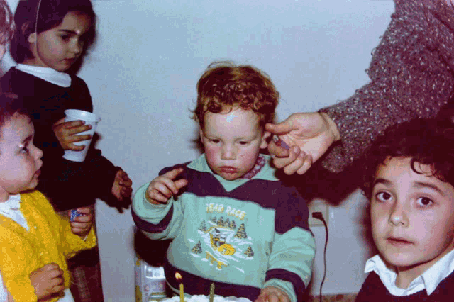 a child wearing a sweater that says tear race