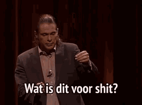 a man in a suit is giving a speech and says wat is dit voor shit