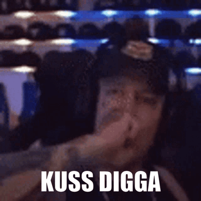 a man covering his nose with his hand and the words " kiss digga " on the bottom right