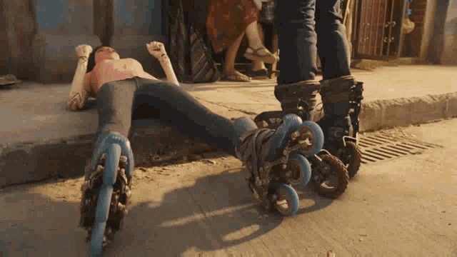 a person wearing roller skates is laying on the sidewalk