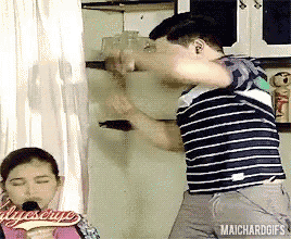 a man in a striped shirt is standing next to a woman in a pink shirt with maichardgifs written on it