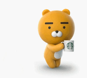 a teddy bear is holding a starbucks mug