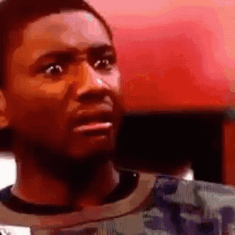 a close up of a man 's face with a shocked look on his face .