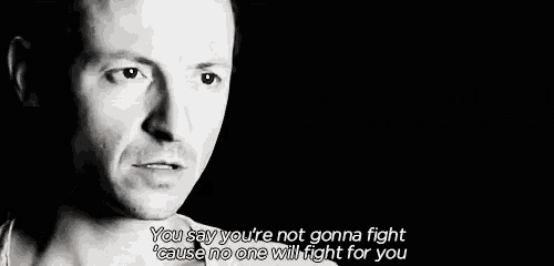 a black and white photo of a man with a quote on his face .