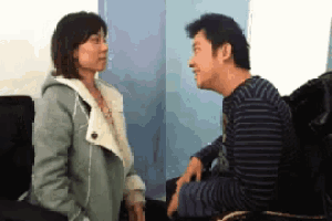 a man and a woman are looking at each other and talking