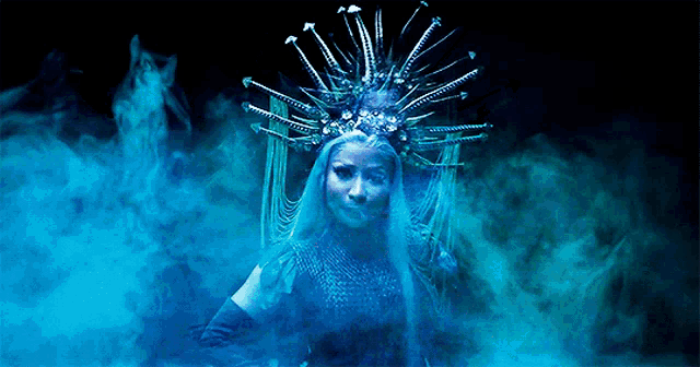 a woman with a crown on her head in a dark room
