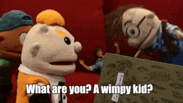 a group of stuffed animals are standing around a book that says " what are you ? a wimpy kid "