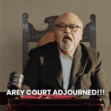 a man in a suit and glasses sitting in a chair with the words arey court adjourned below him