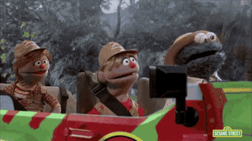 three sesame street characters are driving a car