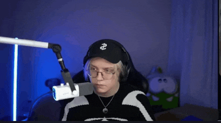 a person wearing headphones and a black hat with the letter e on it