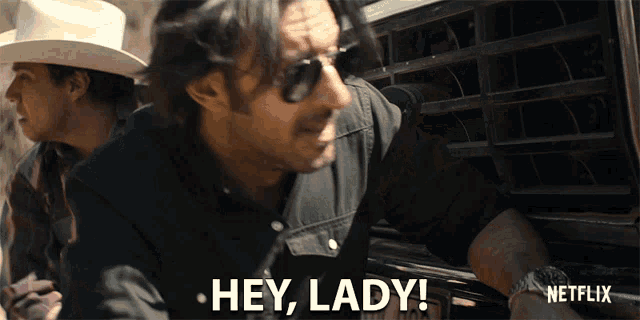 a man in a cowboy hat and sunglasses says " hey lady "