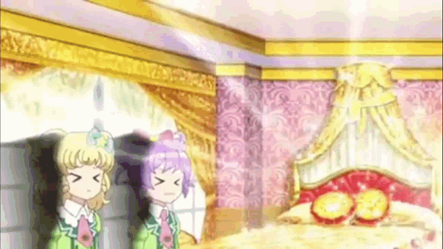 a couple of anime girls standing next to each other in a room with a bed .