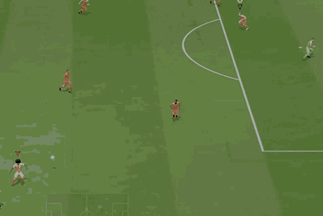 a soccer game is being played on a green field with a goalie in the goal