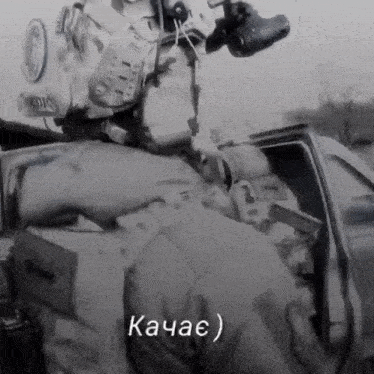 a black and white photo of a man in a military uniform with the word kahac written on the bottom