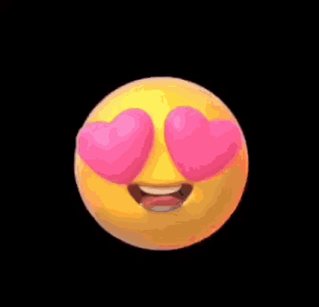 a yellow smiley face with pink hearts in its eyes and tongue sticking out .
