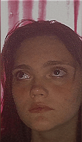a close up of a woman 's face with a red background