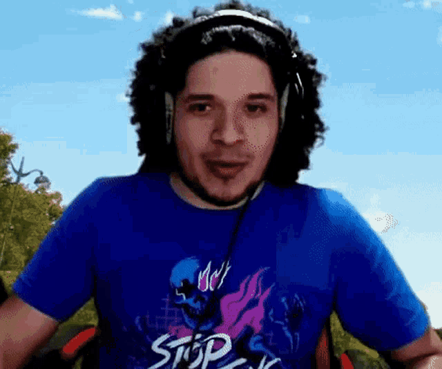 a man wearing a blue shirt that says stop
