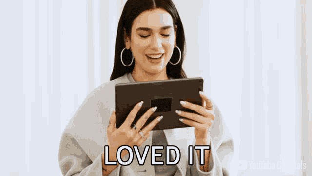 a woman holding a tablet with the words loved it on the bottom right