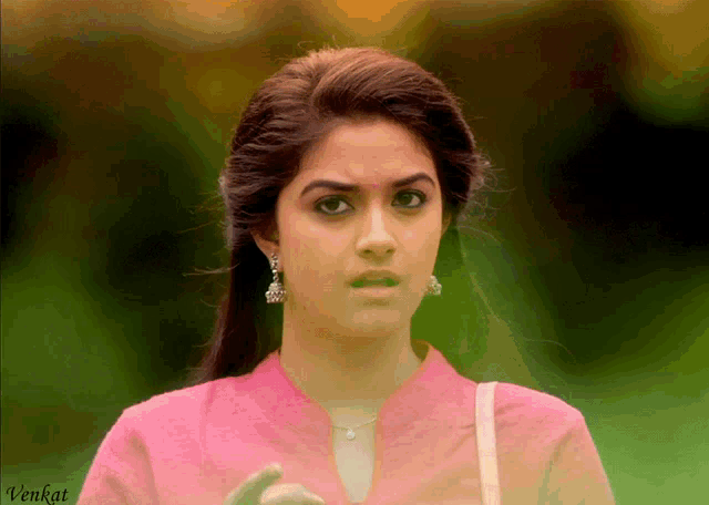 a woman in a pink shirt has the word venkat on the bottom right