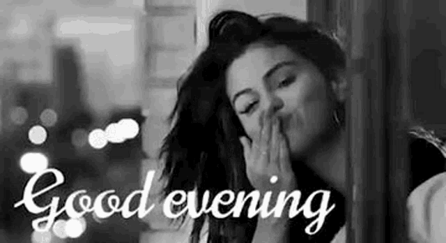 a black and white photo of a woman blowing a kiss with the words `` good evening '' written above her .