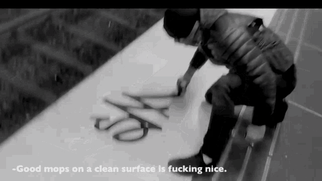 a black and white photo of a person mopping a clean surface with the caption " good mop on a clean surface is fucking nice "
