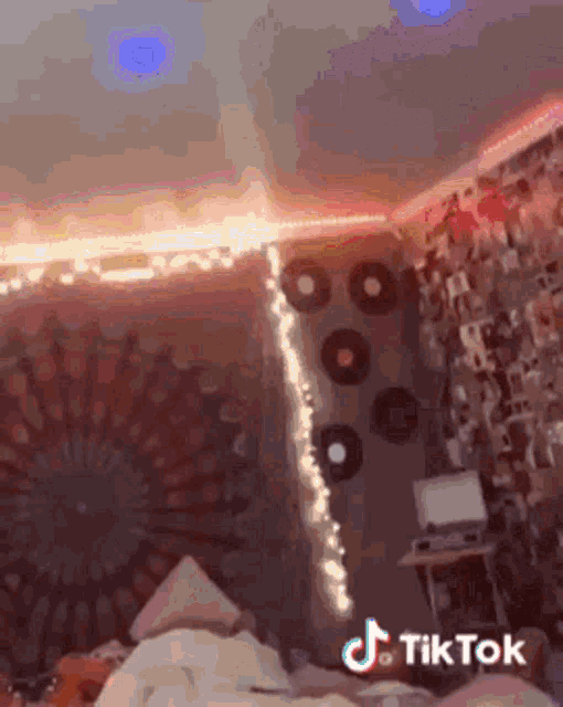 a tiktok video of a bedroom with a tapestry and lights