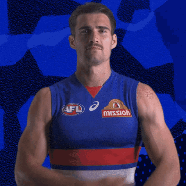 a man wearing a blue shirt that says afl mission