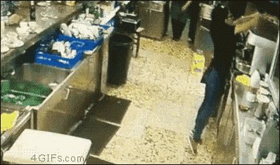 a person standing in a kitchen with a 4gifs.com watermark on the bottom right