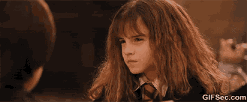 hermione granger from harry potter is making a funny face while looking at a boy .