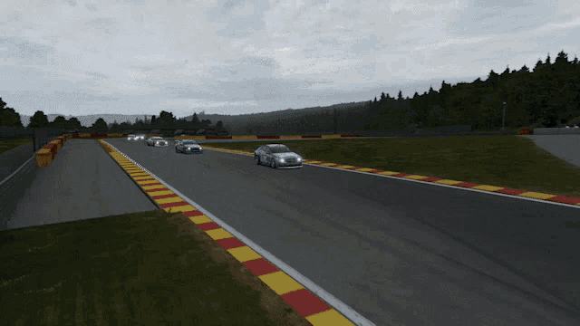 a group of cars are racing down a track