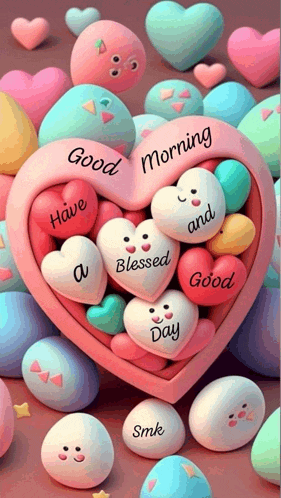 a heart shaped box filled with colorful hearts and marshmallows with faces on them .