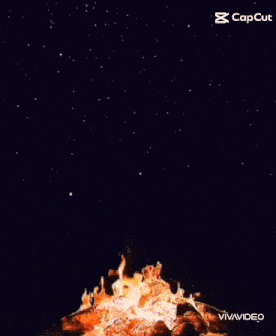 a campfire is exploding in the night sky with a caption that says capcut