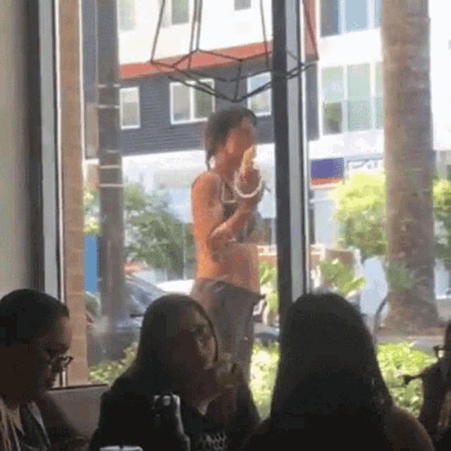 a woman in a bikini is eating an ice cream cone