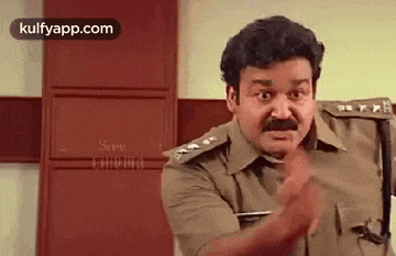 a man in a police uniform is making a funny face and pointing at the camera .
