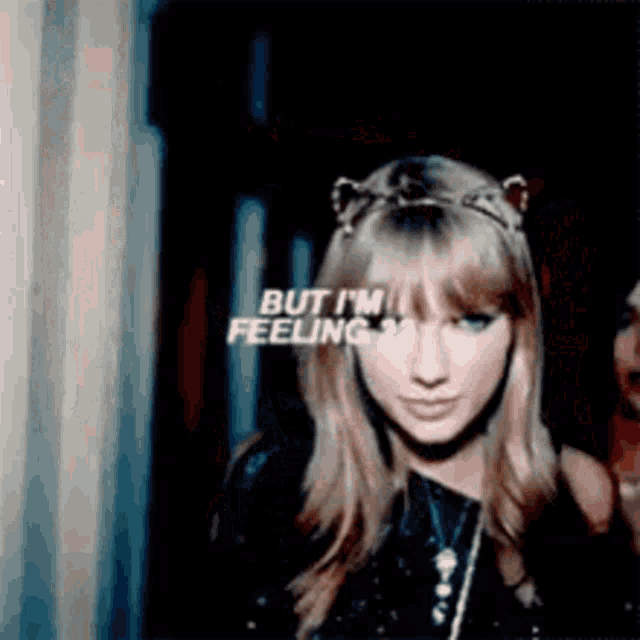 a woman wearing a cat ear headband says but i 'm feeling .