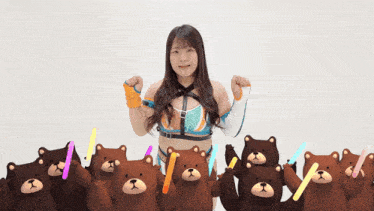 a woman is surrounded by teddy bears and holding glow sticks