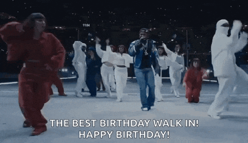 a group of people are dancing on a street and a man is holding a microphone .