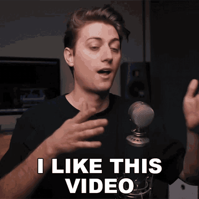 a man speaking into a microphone with the words " i like this video " on the bottom